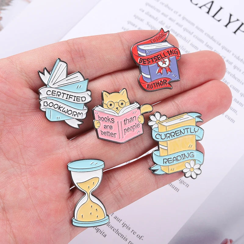 Book Enamel Pins such as, "Bestselling Author," or "Currently Reading."
