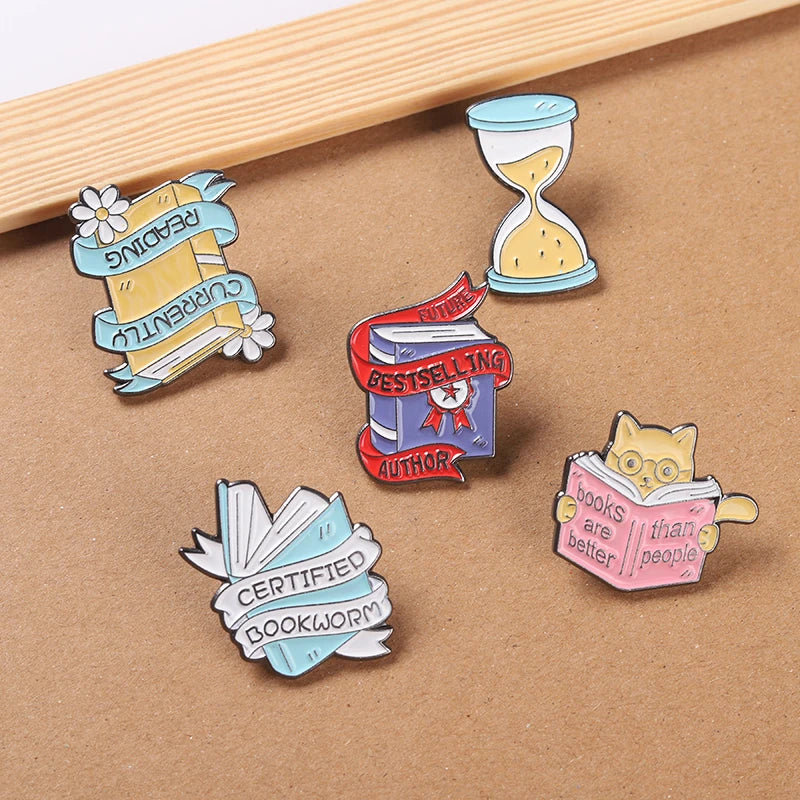 Book Enamel Pins such as, "Bestselling Author," or "Currently Reading."